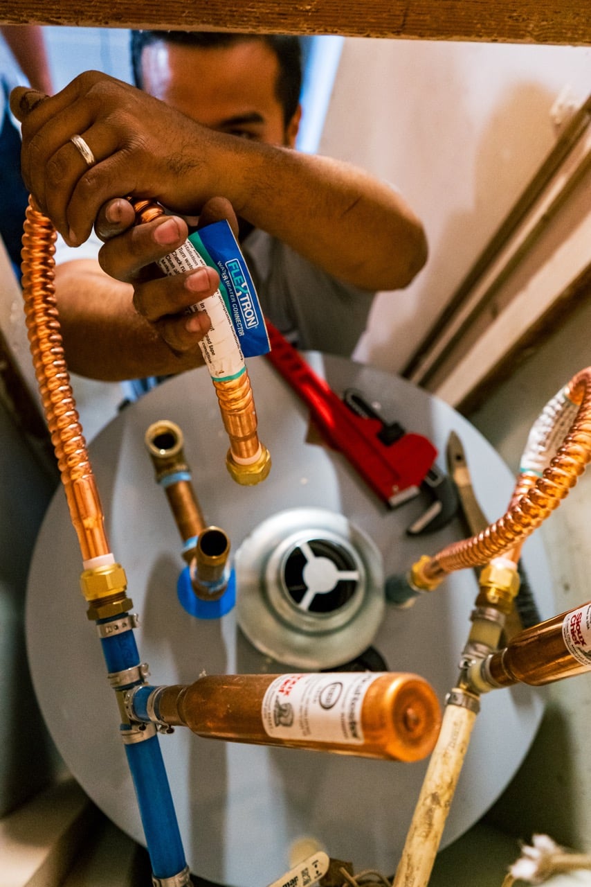 A KMS HVAC company employee performing Residential Water Heater services